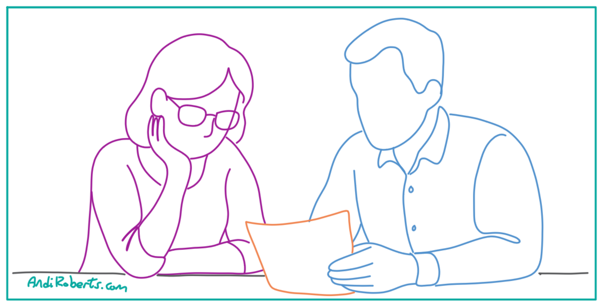 Two people discussing a document as part of reaching an agreement for working in partnership.